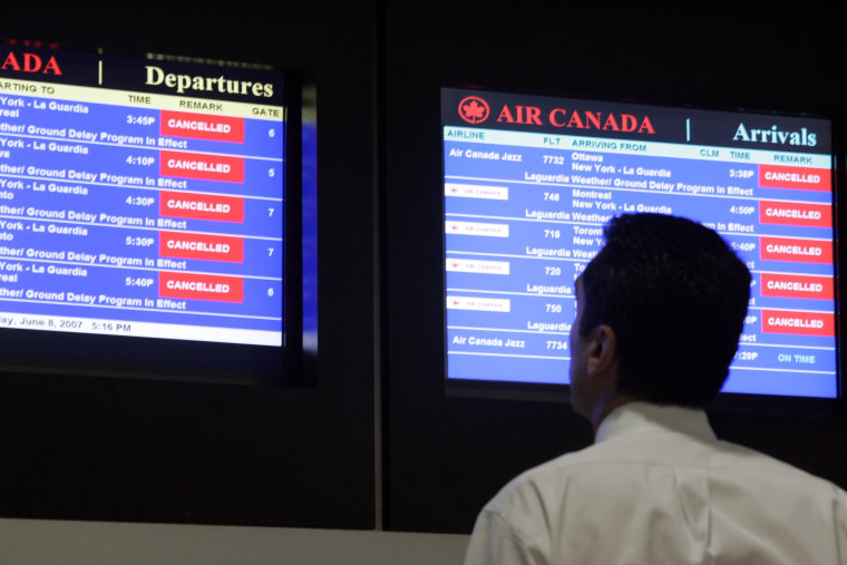 Airline passengers watch for flight delays on the monitors throughout New York's LaGuardia Airport, which falls high on the list.